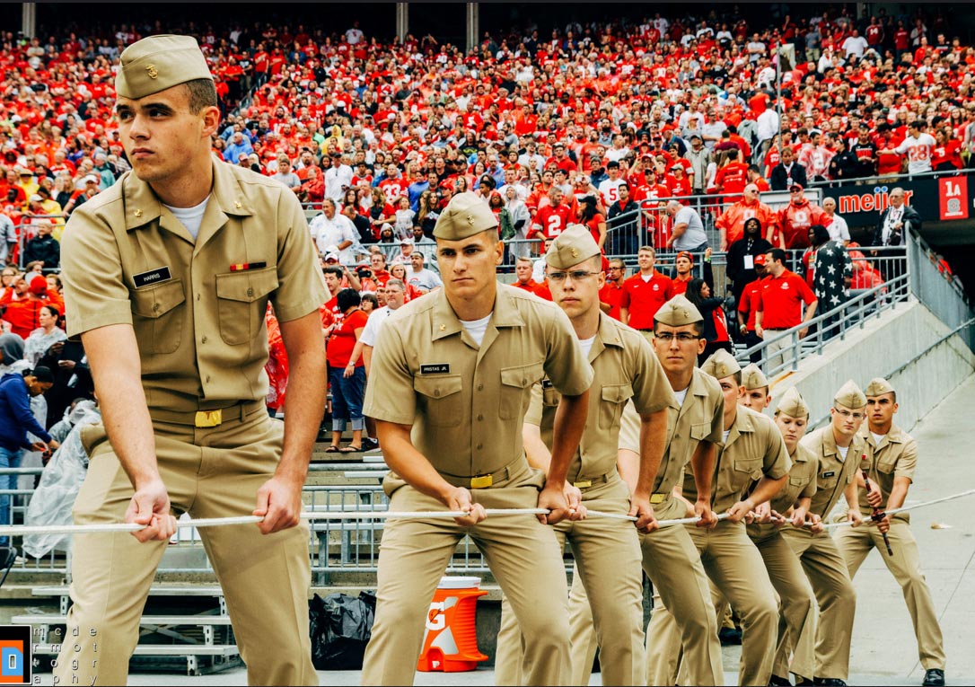 Navy ROTC cadets raise the American Flag at a Buckeyes football game.