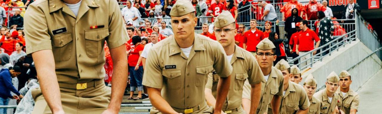 Navy ROTC cadets raise the American Flag at a Buckeyes football game.