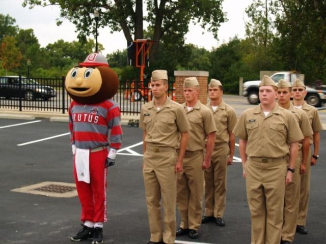 Brutus Buckeye stands at attention with ROTC cadets.