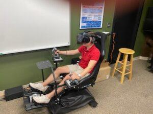 Young man using the VR simulator.